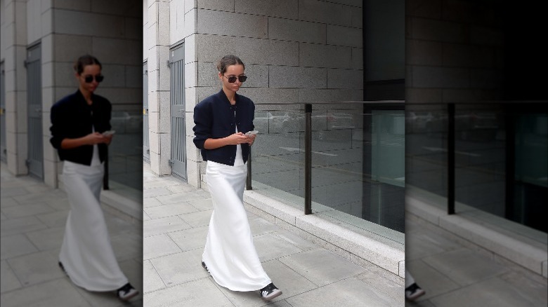 Person in bright white satin skirt