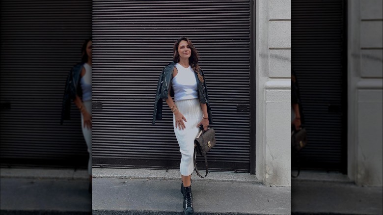 Woman wearing white tank, midi skirt