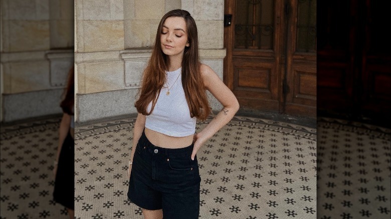 Woman wearing white tank, shorts