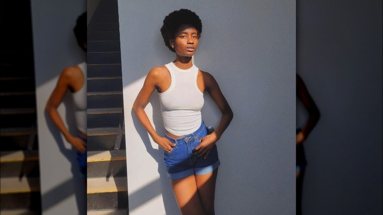 Woman wearing white tank, shorts