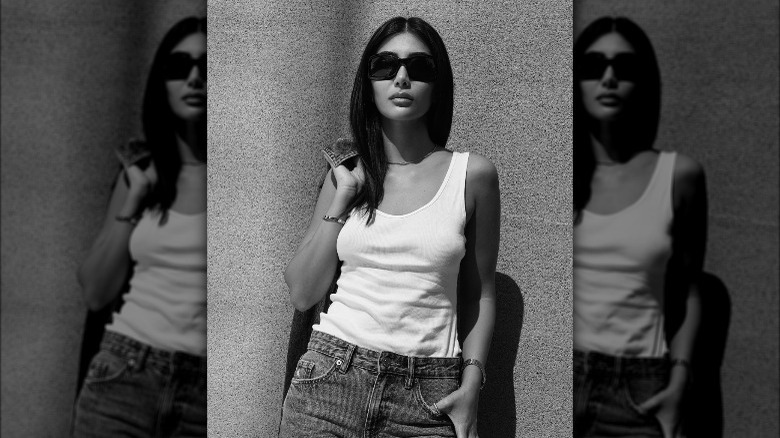 Woman wearing white tank, sunglasses