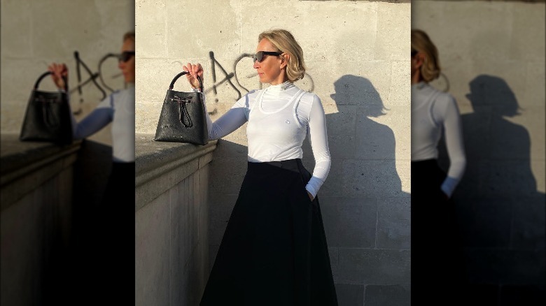 Woman wearing white tank, skirt