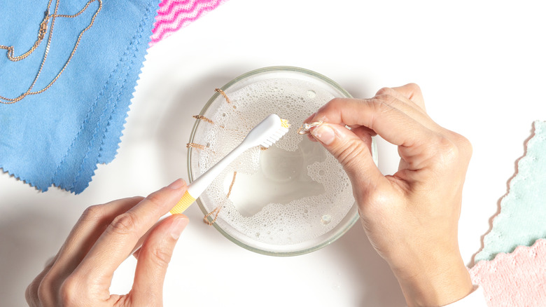 Woman cleaning jewelry at home