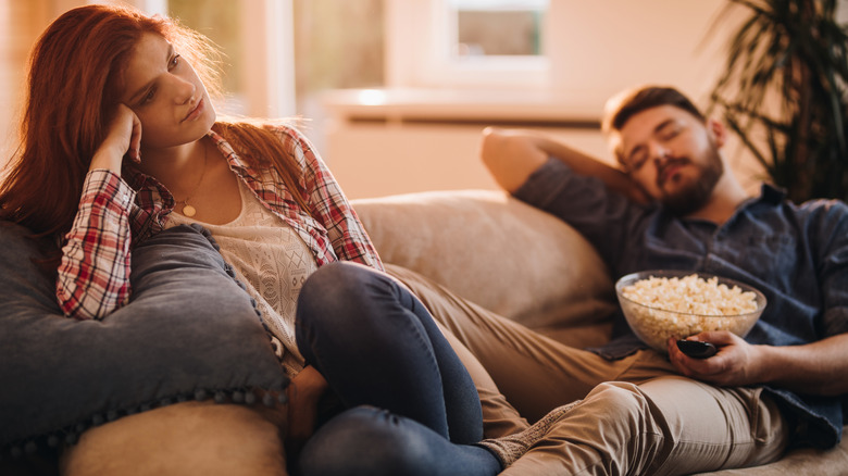 Couple bored watching TV