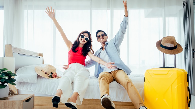 Happy couple in hotel room