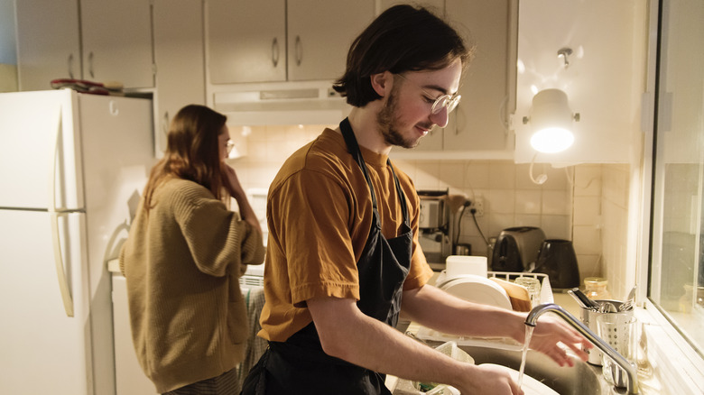 Couple washing dishes together