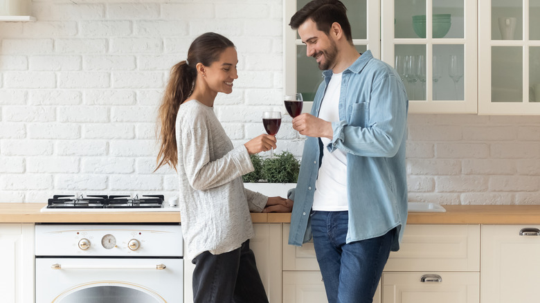 Couple drinking wine in kitchen