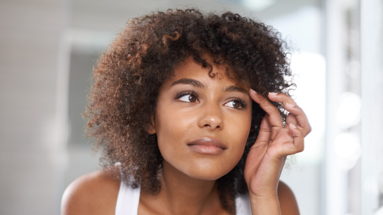 Woman looking in mirror