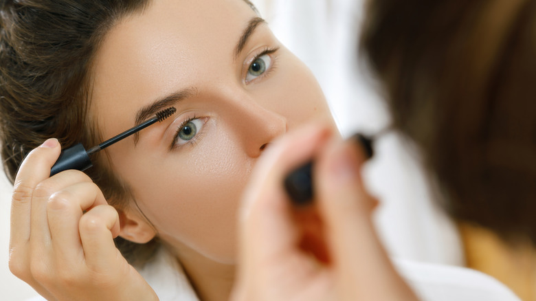 Woman applying eyebrow product