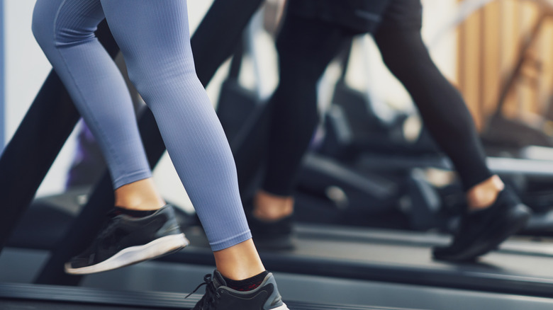 two women working out on treadmill