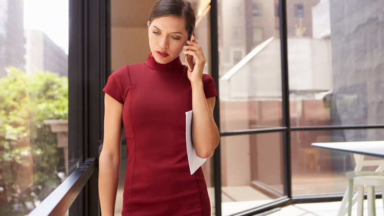 businesswoman in red, high-neck sheath dress