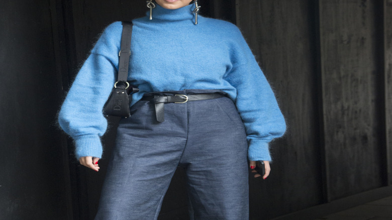 British woman wearing blue turtle neck sweater