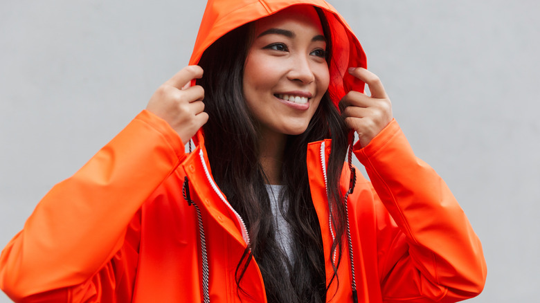 Woman wearing orange raincoat
