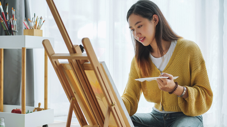 Woman painting at home