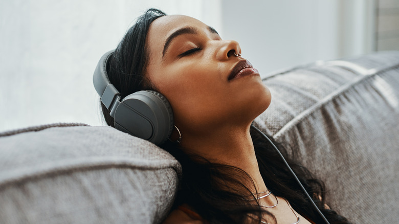 Calm woman listening to headphones