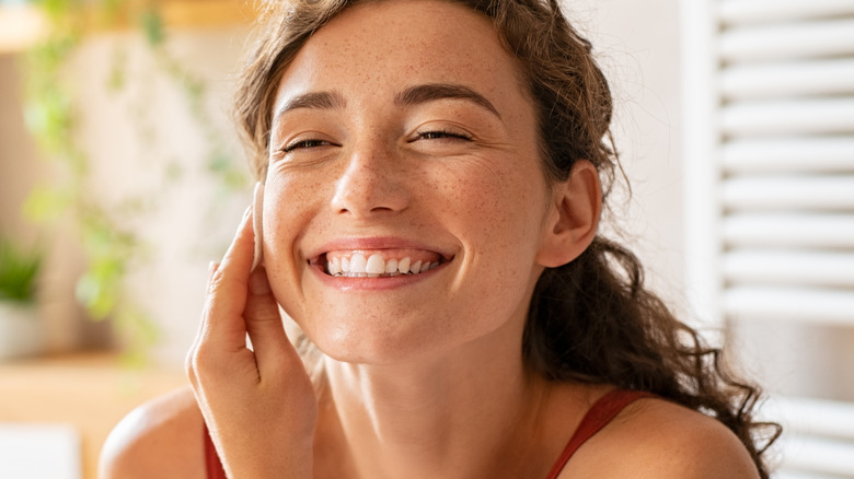 woman cleansing face