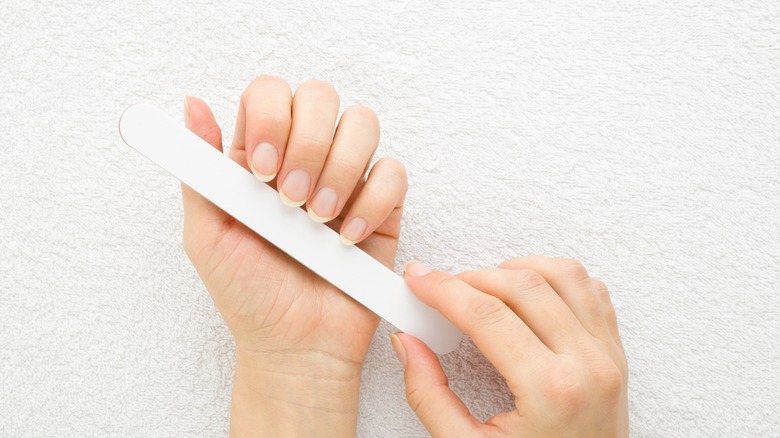 Woman filing nails 