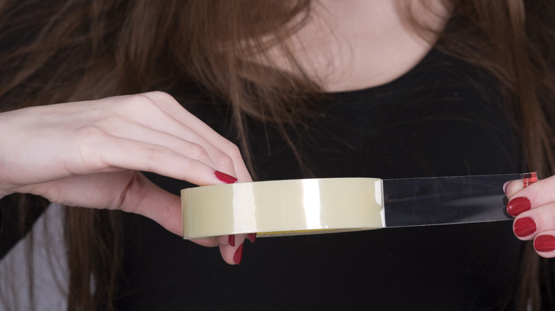 Woman cutting tape