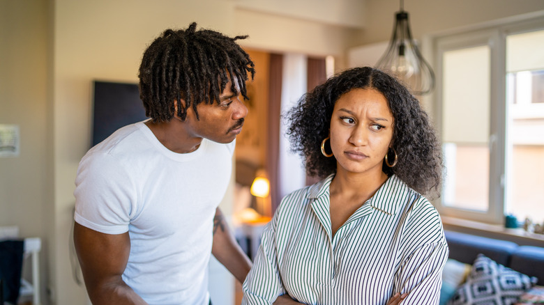 Young couple arguing while woman looks angry