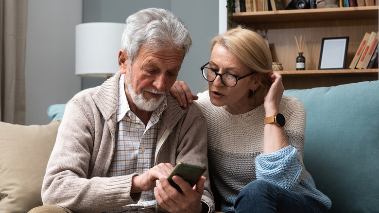 Woman having a discussion with man on sofa