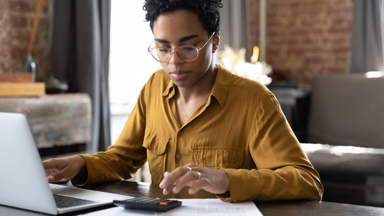 Black woman using calculator