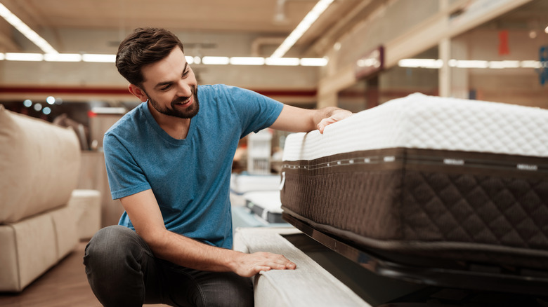 man shopping for a mattress