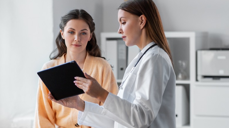 Woman talking to doctor