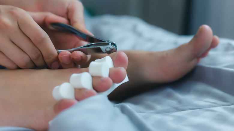 woman cutting toenails