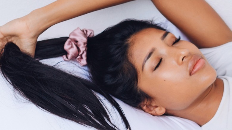 Woman sleeping with hair scrunchie