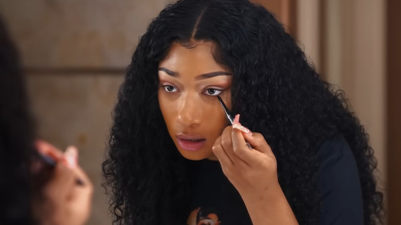 Megan Thee Stallion applying eyeliner