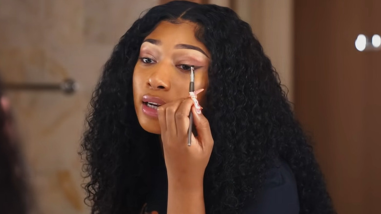 Megan Thee Stallion applying eyeshadow wing