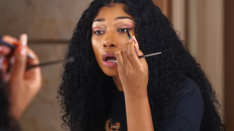 Megan Thee Stallion applying eyeliner