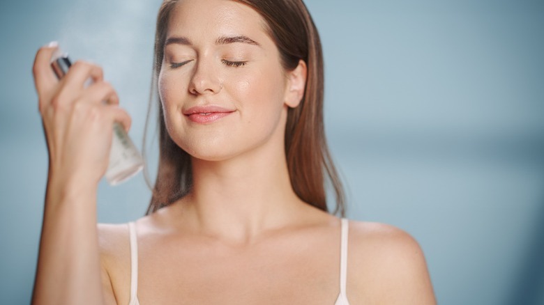 Woman spraying a face mist