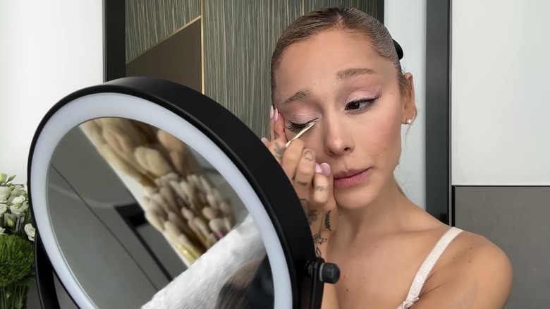 Ariana Grande applying eyeshadow