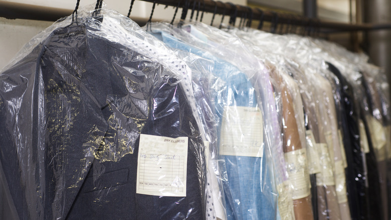 dry cleaned clothing on rack