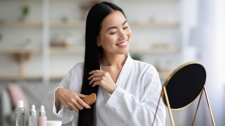 Woman brushing long hair