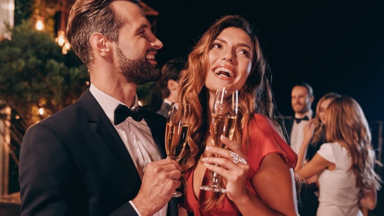 Couple drinking champagne at party