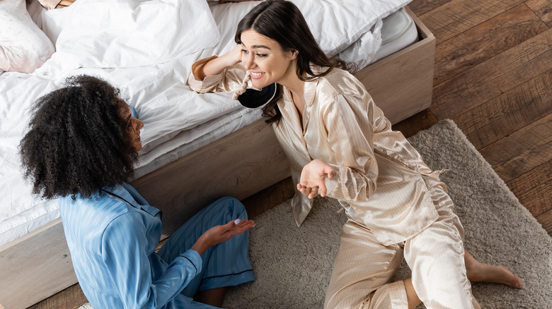 Two friends talking in pajamas