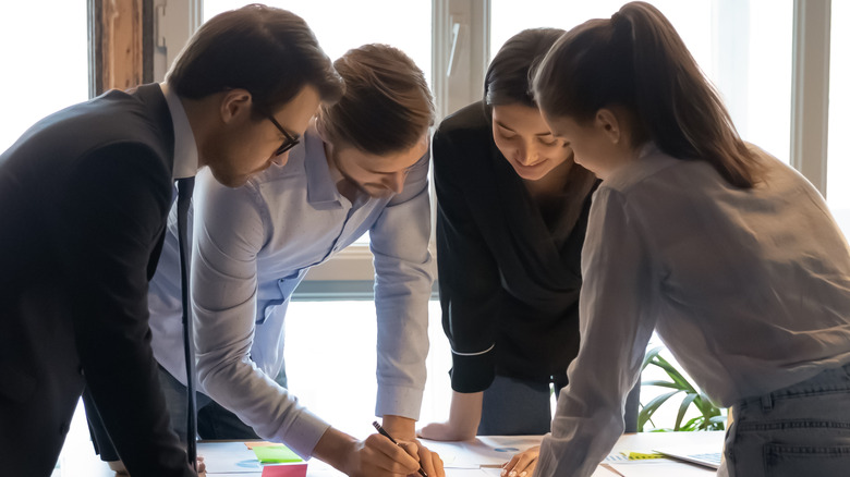 a group of coworkers discussing work