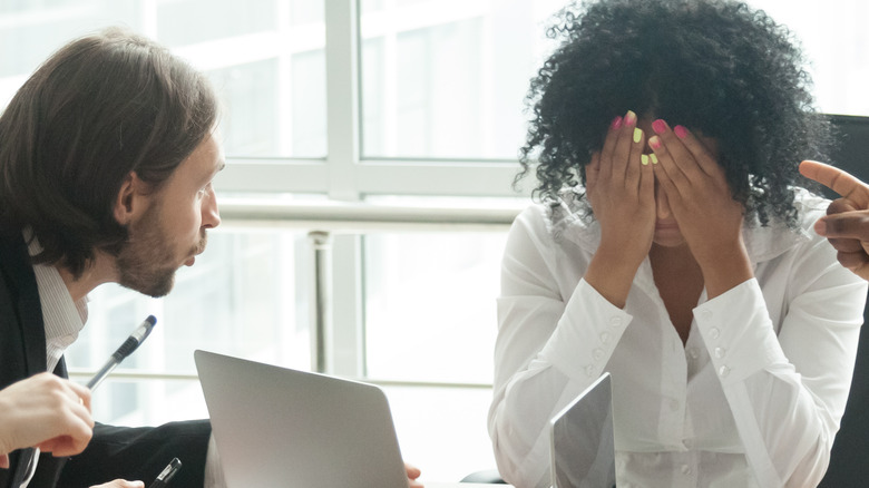 criticized employee hiding her face