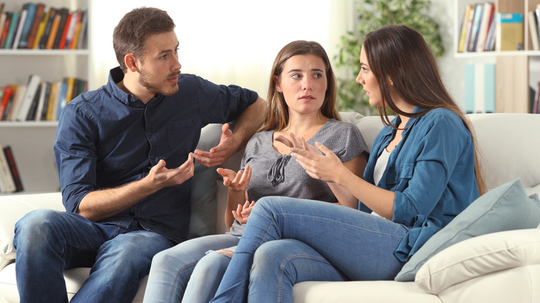 three friends on couch arguing