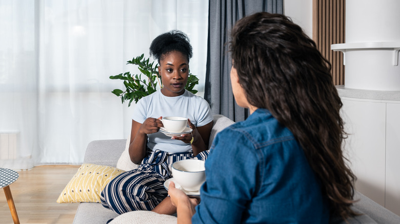 two friends talking with tea