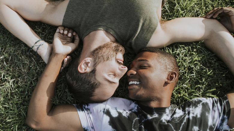 two men affectionate on grass