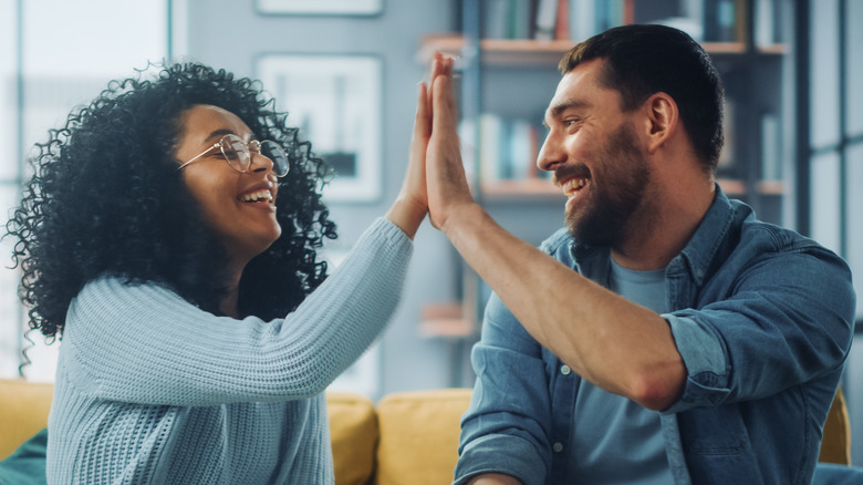 woman and man high-fiving