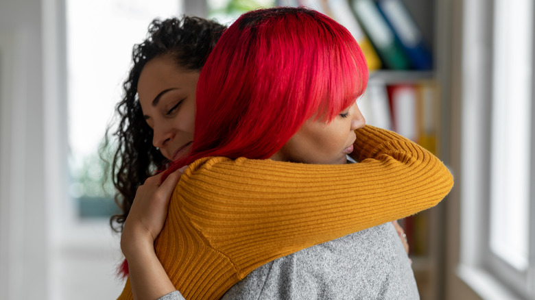 Two friends hugging