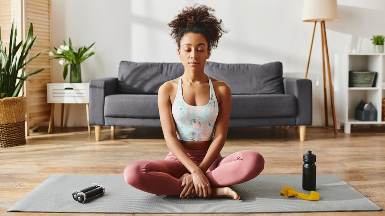 Curly-haired woman practicing yoga