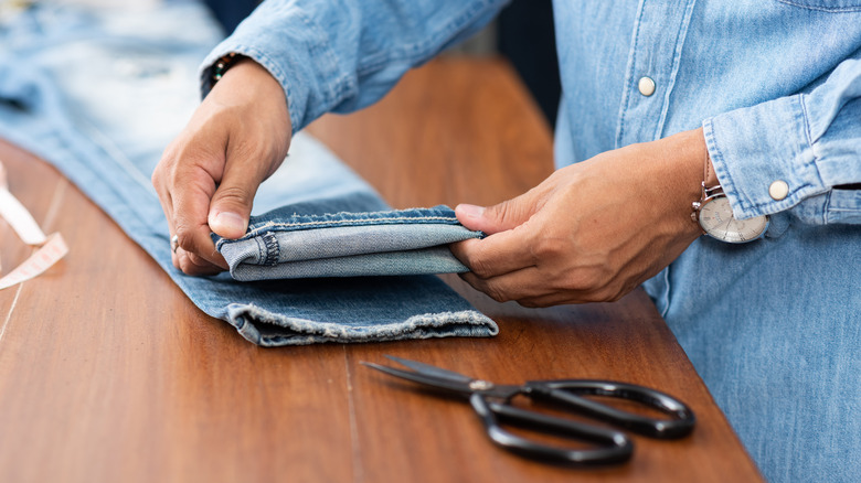 tailor measuring denim jeans