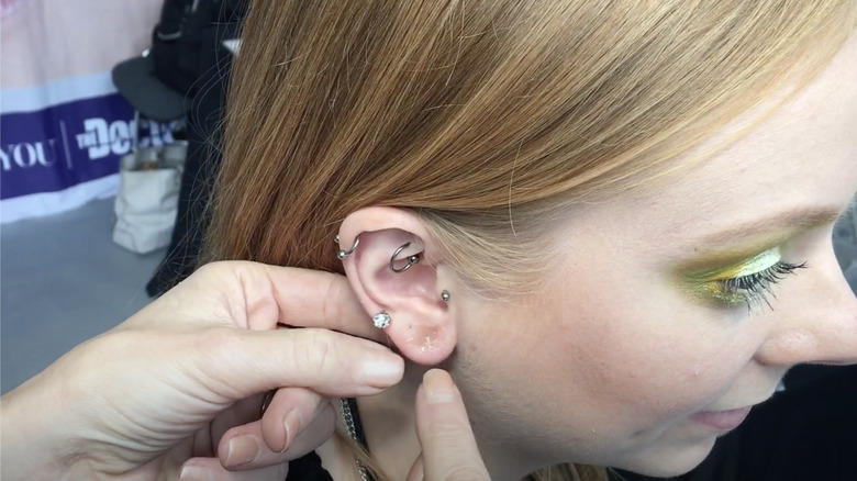 A woman having her piercing concealed