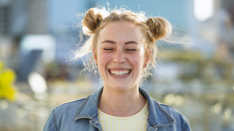 Smiling woman with space buns