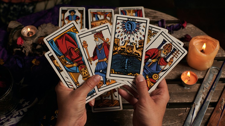 Person holding tarot cards
